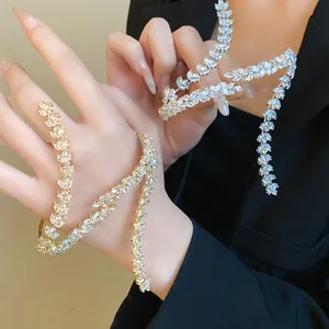 Close-up detail of a sparkling cubic zirconia wheat ear bracelet on a model's wrist.