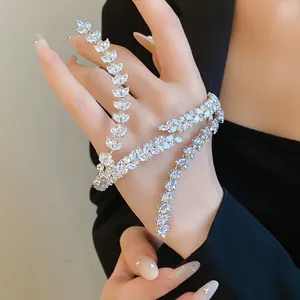 Macro detail of elegant marquise cut zircon wheat ear bracelet worn on woman's hand