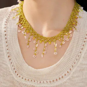 Detailed close-up of handmade green and pink beaded floral necklace for women