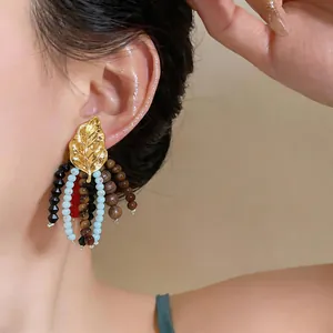 Vintage ethnic style gold leaf stud earrings with multi-color glass and wooden bead tassels.