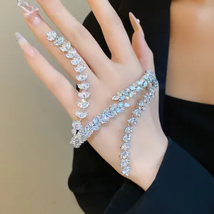 Elegant detail of a sparkling zircon wheat ear hand chain bracelet on a black background