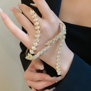 Detailed macro shot of elegant golden wheat ear hand chain with sparkling cubic zirconia