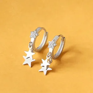 Close-up detail view of sterling silver hoop earrings with sparkling star charms