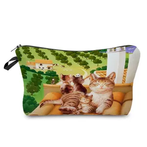 Close-up view of a travel makeup bag featuring a cute cat family illustration print.