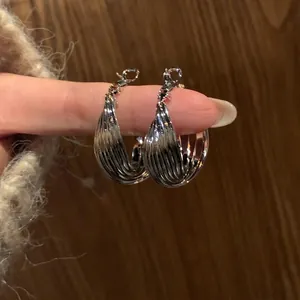 Minimalist silver-tone textured metal hoop earrings with elegant striped design for women