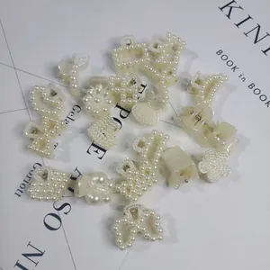 Detail view of pearl-studded claw clips in various shapes like hearts and flowers
