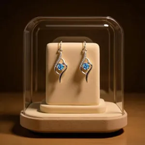 Close-up view of S999 sterling silver flower earrings featuring sparkling blue zircon