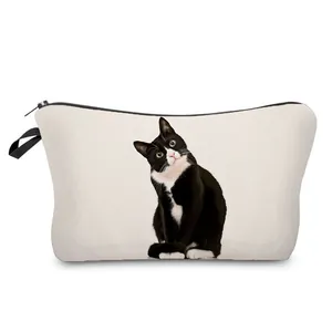 Detailed close-up of a cute tuxedo cat print on a minimalist white canvas makeup bag