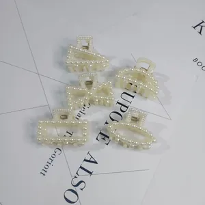 Detail view showing five different geometric shapes of elegant pearl-encrusted hair claw clips