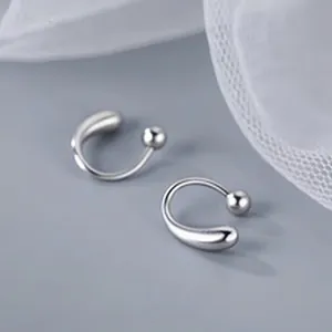 Detail of S999 sterling silver waterdrop earrings with a polished minimalist finish