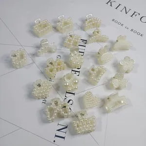 Selection of elegant pearl-encrusted hair claw clips in various shapes on a minimalist background