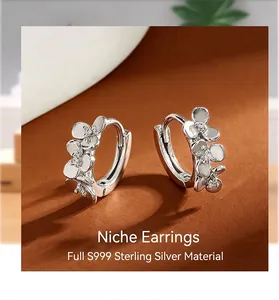 Close-up of S999 sterling silver flower hoop earrings with small zircon details