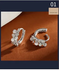 Close-up view of S999 silver flower hoop earrings with sparkling zircon details.