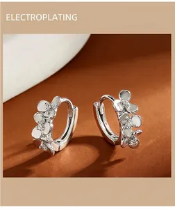 Close-up of S999 silver flower earrings showing smooth petals and sparkling zircon stones.