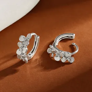 Elegant S999 silver flower hoop earrings with zircon petals and white enamel finish.