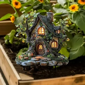 Beautifully detailed fairy house garden stake placed in a flower pot decoration