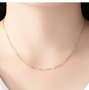 Detailed view of an elegant 14K gold-plated clavicle chain worn on the neck.
