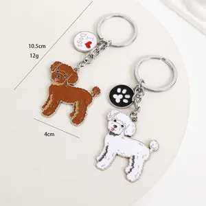 Detailed size view of poodle dog keychain pendants in brown and white finish.