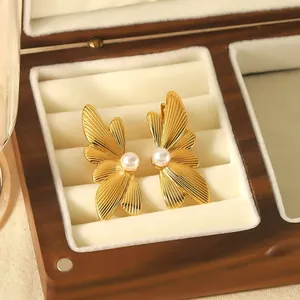 Elegant golden stainless steel butterfly wing earrings with pearl in wooden jewelry box