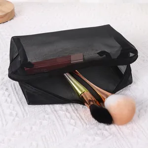 Detailed view of a black mesh makeup bag showing large capacity storage with brushes