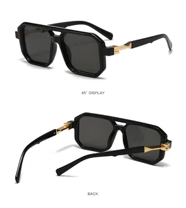 Detailed views of black double bridge sunglasses with gold metal temples and square frames.
