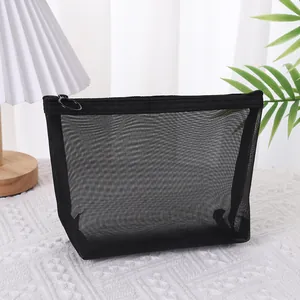 Detailed view of a black mesh cosmetic bag with standing structure and zipper ring puller