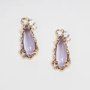 Close-up of teardrop glass pendants with CZ copper frame for DIY jewelry making.