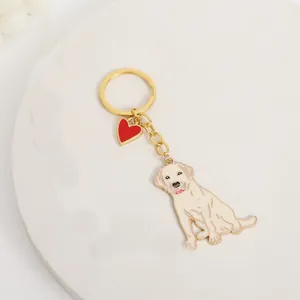 Close-up detail of a zinc alloy golden retriever dog keychain with red heart charm