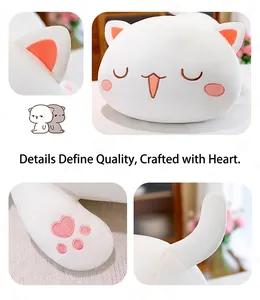 Close-up detail of soft white cat plush toy featuring heart-shaped paw embroidery.