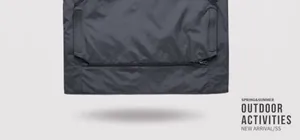 Macro view showing the sturdy zipper and pocket detail on a black outdoor vest.