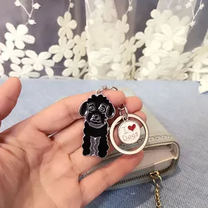 Detailed close-up of a black poodle dog zinc alloy keychain with an I Love Dogs charm on a bag