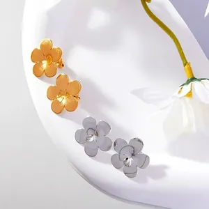 Close-up detail of golden and silver floral stainless steel earrings for women's gift