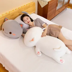 Cute plush cat hugging pillow for sleeping, soft white cat long body toy on bed.