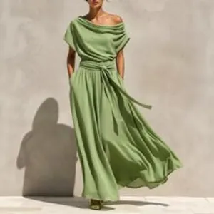 Close-up of a sage green off-shoulder maxi dress with a belted waist and pleated fabric