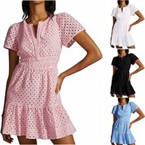 Detailed view of short-sleeved eyelet lace mini dress in pink, white, black, and light blue