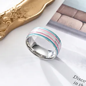 Detailed shot of stainless steel ring with blue, pink and white enamel stripes