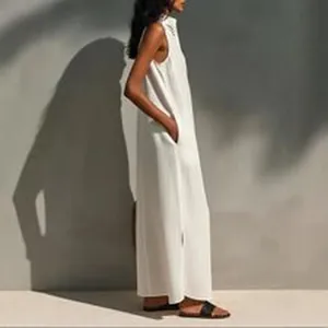 Elegant minimalist sleeveless white maxi dress with side pockets shown from a side profile