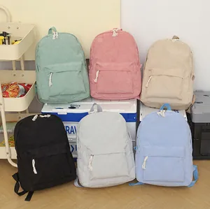Group of colorful corduroy backpacks for women in various pastel and neutral tones