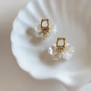 French-style pearl petal stud earrings with gold finish and crystal center