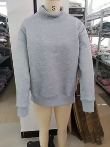 Detailed view of a grey mock neck loose fleece sweatshirt on a female mannequin