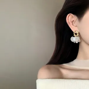 Elegant French style gold petal pearl earrings for women with minimalist aesthetic