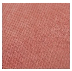 Macro detail of soft pink corduroy fabric showing fine ribbed texture for backpacks