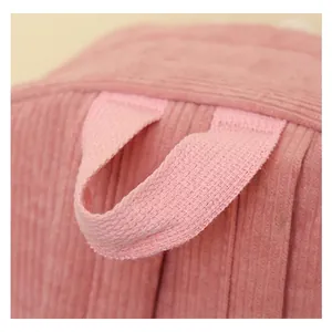 Close-up macro view showing the durable fabric handle of a pink corduroy student backpack