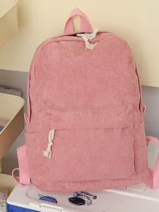 Pink corduroy school backpack with large front pocket and white rope zipper pulls