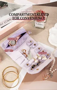 Detailed interior view of purple crocodile pattern jewelry roll with organized sections