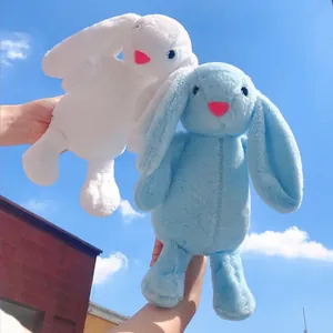 Cute 8-inch white and blue plush bunny dolls held against a bright blue sky background