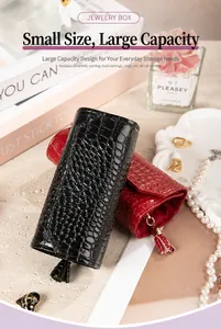 Detail of crocodile pattern portable jewelry storage roll with elegant tassel zipper