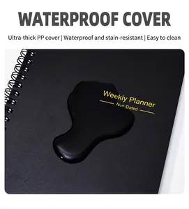 Macro view of waterproof black PP cover weekly planner featuring spiral binding detail