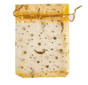 Detail of golden star and moon organza drawstring gift bag for jewelry or candy storage.