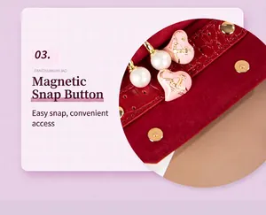 Close-up of red velvet jewelry bag showing pink heart charm and magnetic snap button